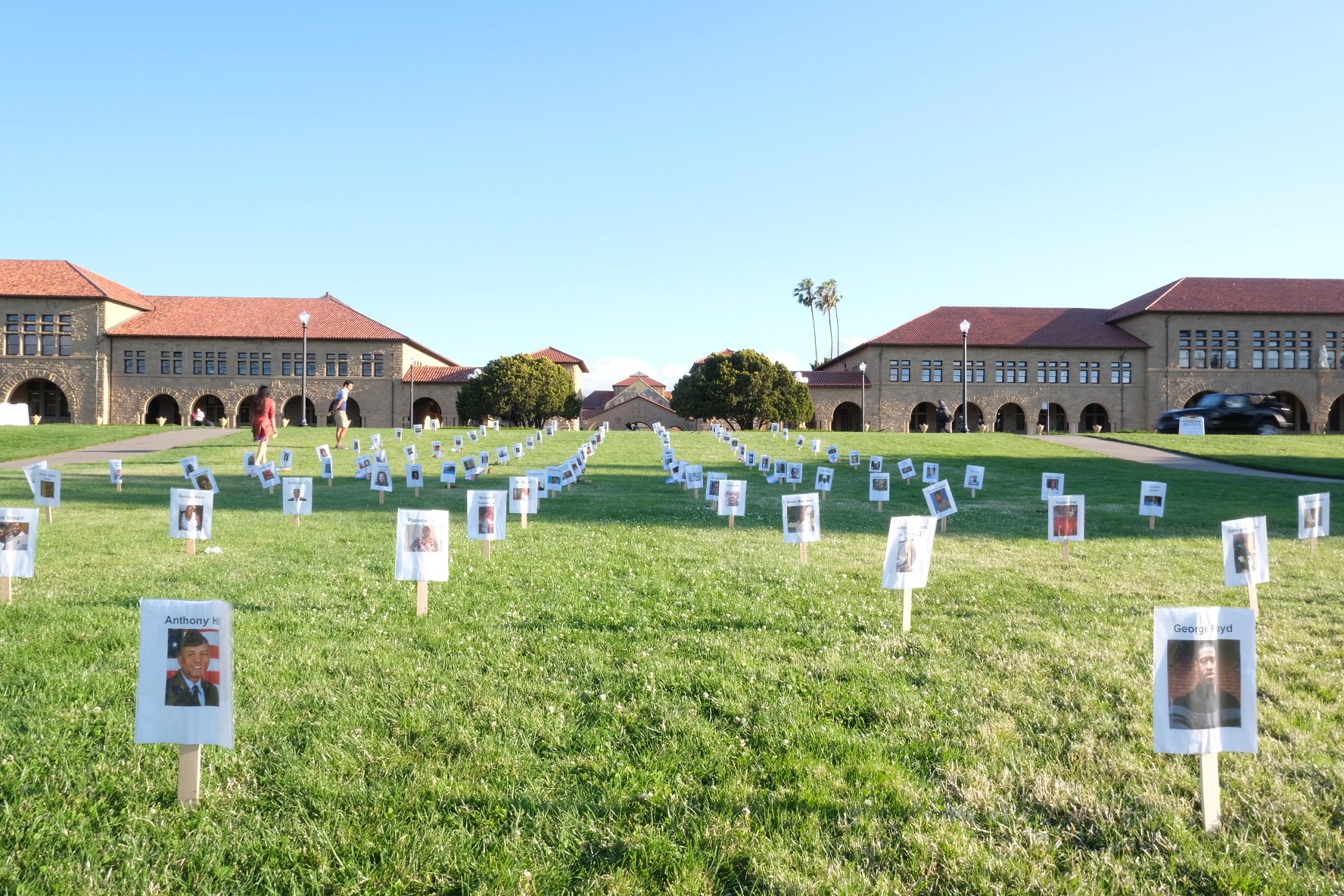 Handmade signs form neat rows across the grass of the Oval, each bearing the name and face of a Black person killed by racial violence and police brutality.
